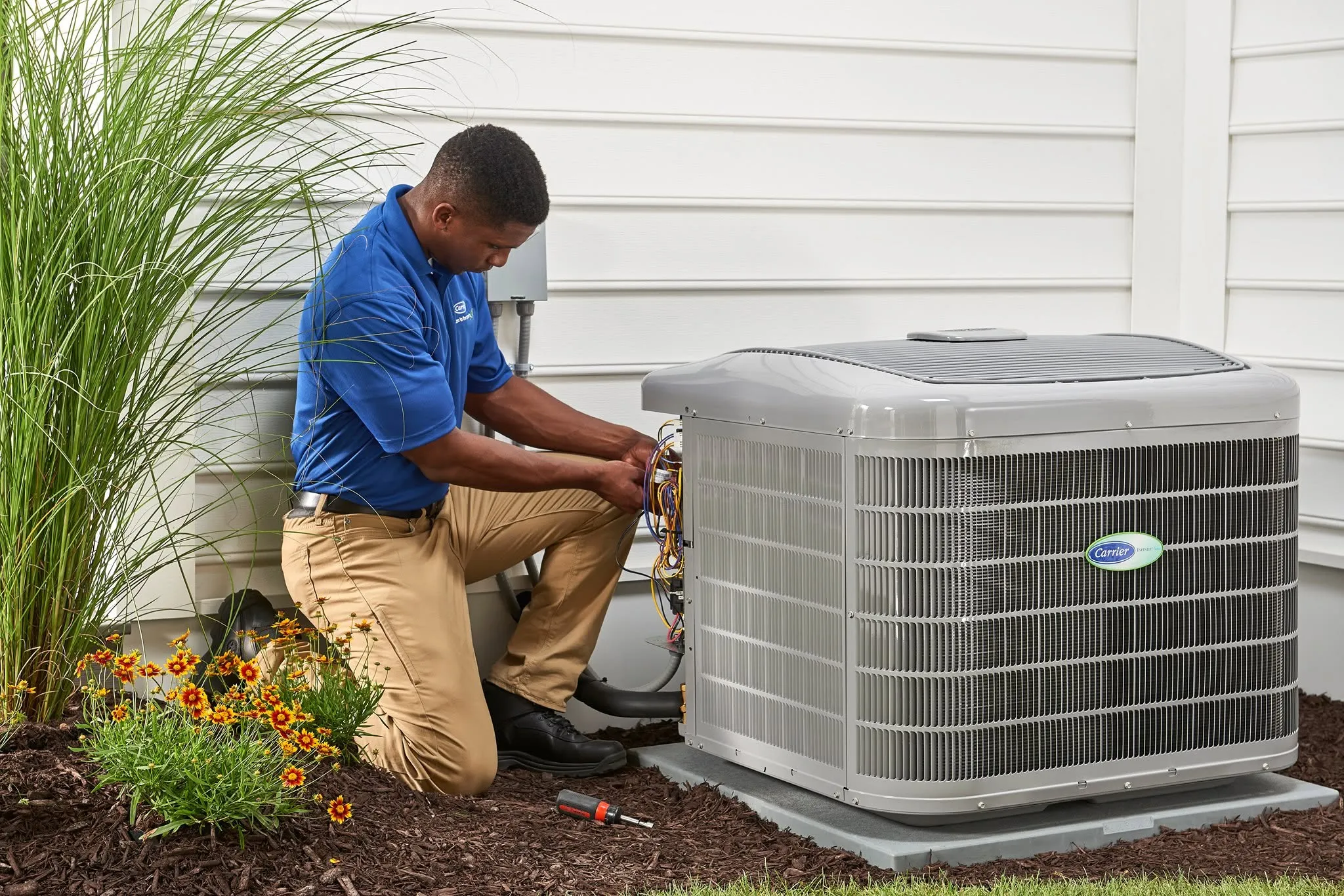 A Snazzy technician working on an outdoor air conditioning unit