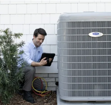 Snazzy technician inspecting an outdoor air conditioning unit